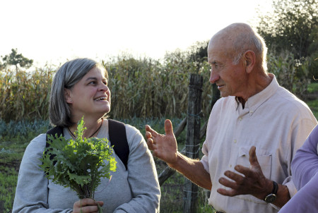 Master of the La Campana farm Santiago Perez exchanges news with teacher of organic gardening Clara Rodriguez. Berza (kale) plays an important part in Asturian menu.